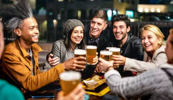happy-friends-group-drinking-beer-at-brewery-bar-outdoors.jpg